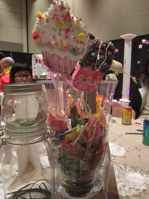 Our maid's personal table decorated with cupcake decor, as well as a jar of lollipops and taffies.