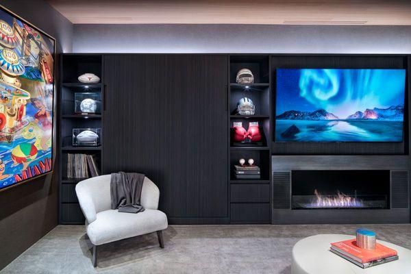 Modern media wall with cozy fireplace and Murphy bed designed by eggersmann