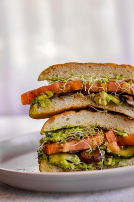 Avocado Veggie Sandwich (V) | Toasted ciabatta, avocado, marinated sliced tomatoes, pickles, cremini mushrooms, alfalfa sprouts, vegan aioli