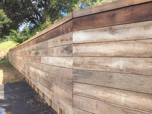 Concrete retaining wall coverd by French Oak from the wine industry.