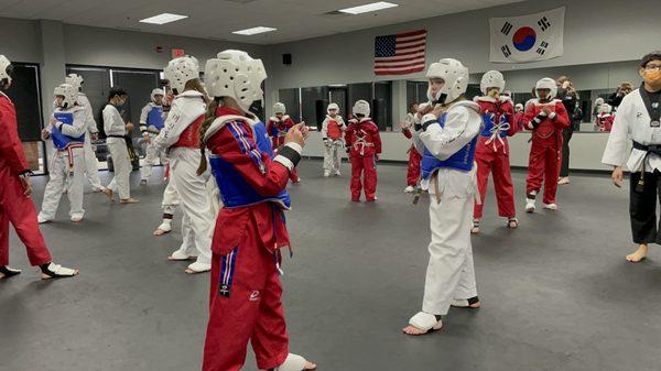 Taekwondo students sparring