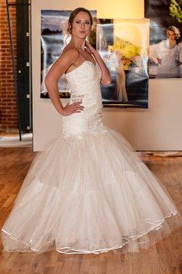 Mermaid strapless lace gown with side peek-a-boo and tulle skirt.