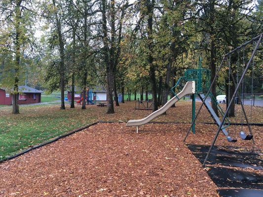 big slide, swings with one for baby, merry-go-round, picnic tables and playground.