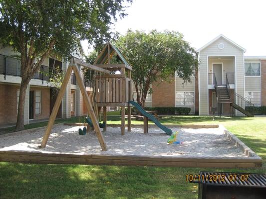 Our beautiful courtyard with swing set, sand box, picnic tables and bar-b-que pits.