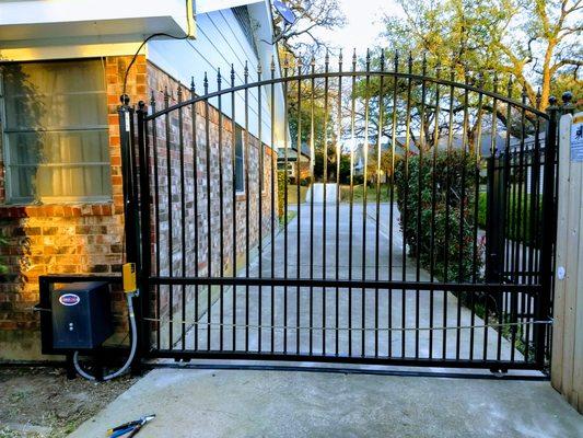 Wrought iron slide gate with automatic gate opener.