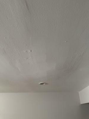 Horrible spackle and paint job on ceiling.