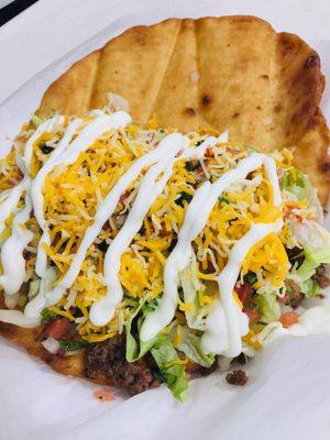 Bonita sandal. Beef, refried beans, lettuce tomato cheese guacamole, pico and sour cream on a fried flatbread. Yummmm