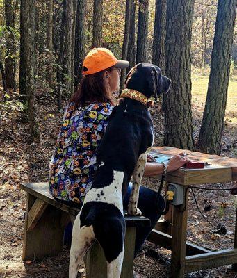 Gunner helping field judge a station during Halloween fun shoot