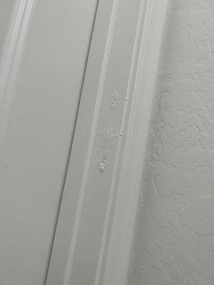 Bad patch job on trim near closet - clearly holes for hinges had been drilled on the wrong side