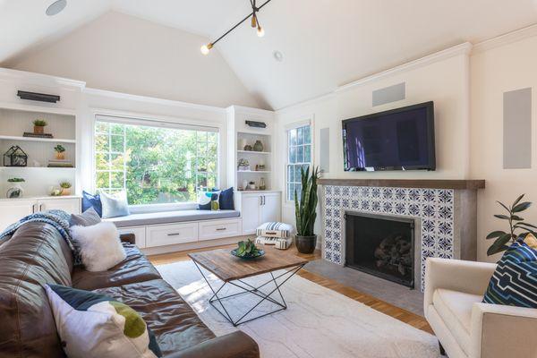 Living room renovation including fireplace, built-in cabinets, furniture, and decor.