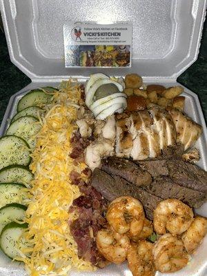 Three meat shrimp steak and grilled chicken loaded salad