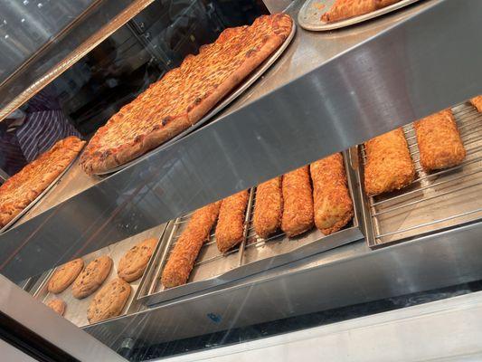 Food court pizza, chicken bake, and cookies.