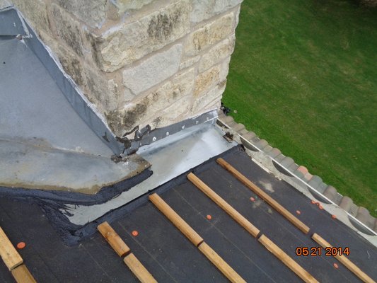 Installed new flashing around the chimney for water to flow out properly.