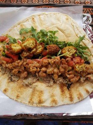 Vegan Wrap: Ful (Fava bean) wrap with arugula, falafel, tomatoes, eggplant salad