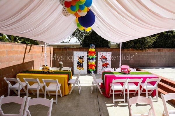 Paw patrol tent decor with balloon garland and centerpieces