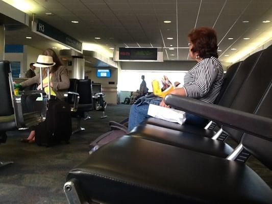 Some random passenger eating a Nathan's burger at gate H3