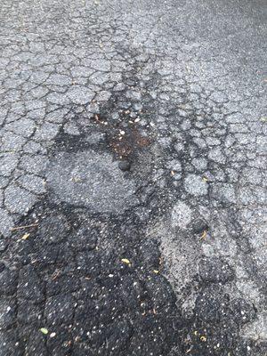 Parking lot dangerous broken uneven ground