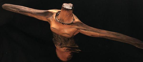 Sculpture from a Pine tree branch of a dancing ballerina.