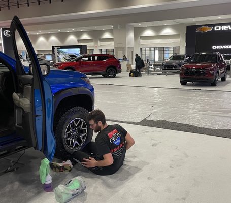 A technician from Berger Mobile Detailing preparing vehicles for the Washington Auto Show.