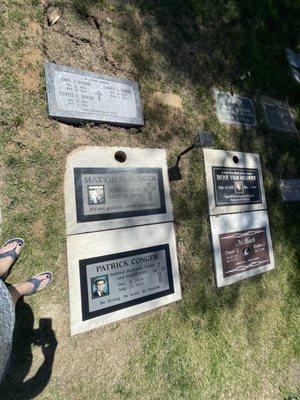 We paid for a custom cement border with two flower-holders much like the ones surrounding our headstone (top-left) in this picture.