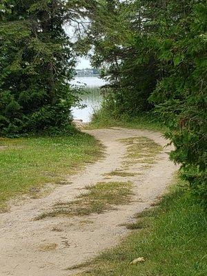 Across from site 31. Access to the lake.  Not a beach as its rocky, but nice to play in or dogs to swim.