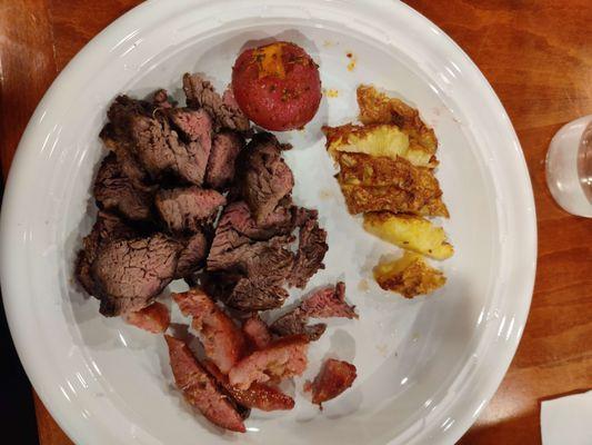 selection of items from the grill plus a potato