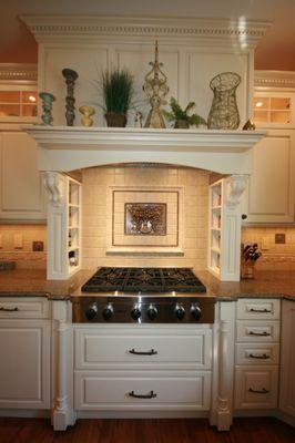 Stove with cabinet drawers below and mantle above