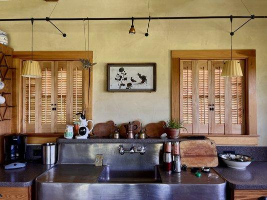 Natural shutters with traditional louvers in modern farmhouse