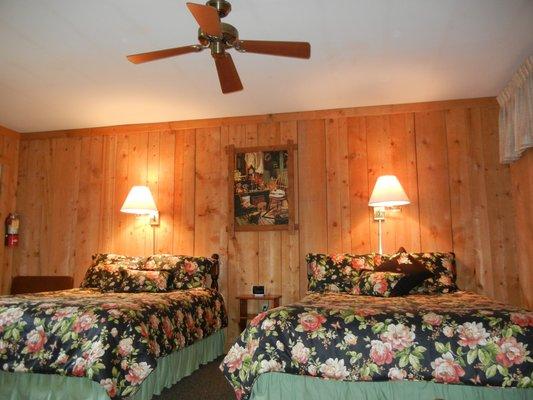 Ground level room with cozy barn siding and 2 queen beds; microwave and refrigerator