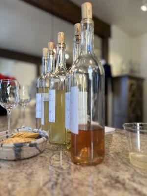 Sampling white wines at various stages of aging for quality and to gauge if they are ready for bottling.

by Anne T.