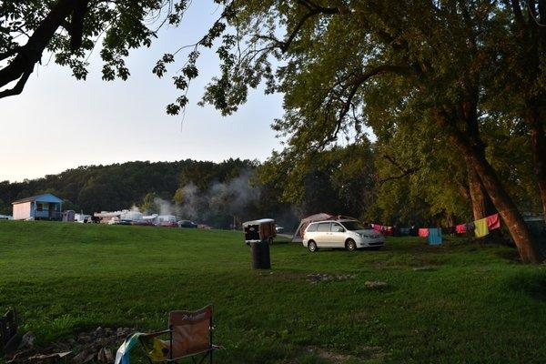 Site on the river looking N/NW towards road, motorhome campers, & only bathroom. Our nearest neighbors on right.