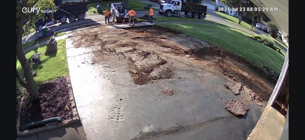 Old driveway being removed to make way for crushed stone.