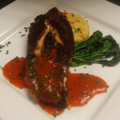 Red snapper with shrimp and grit cake with broccoli rabe and red pepper coulis sauce