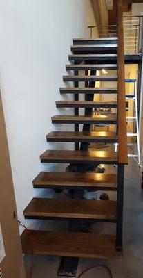 Mono stringer stairway and platform with oak treads.