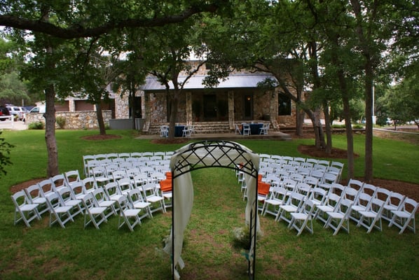 Outside wedding ceremony on tree shaded lawn near Georgetown, TX