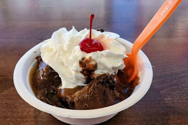 Double chocolate chip ice cream with hot caramel sauce with whipped cream and cherry on top