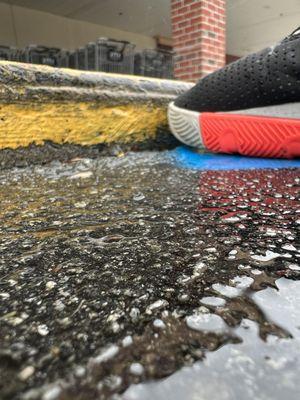 Extreme close up of concrete curb at the end of the Handicap Access Cross walk