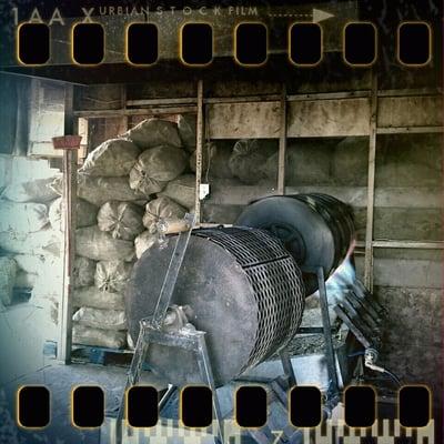 Mountains of bags of chile behind the roaster.