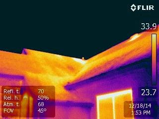 Roof/attic fan pulling warm air from home and heating the roof.  Attic needs air sealing and better insulation measures.