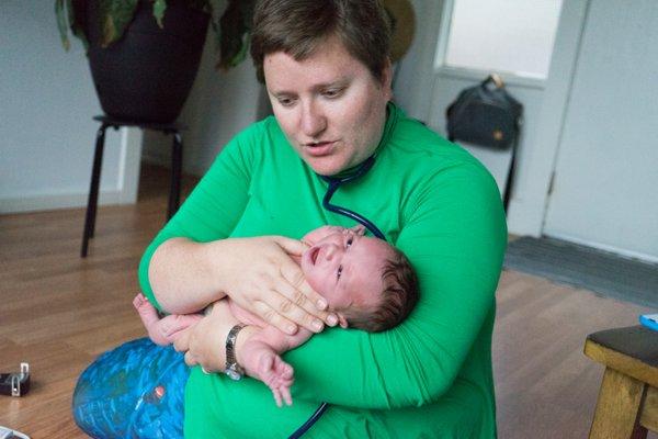 Emily examining my newborn after we came home from the hospital.