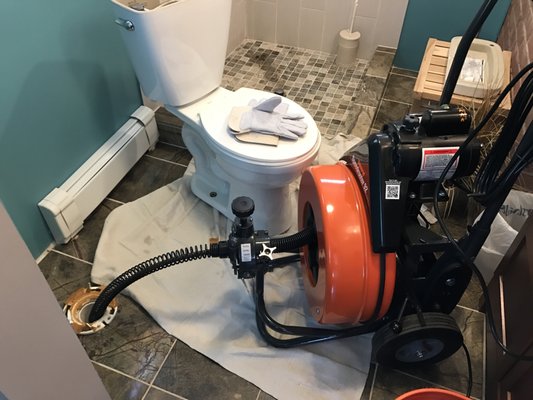 Cleaning a main line through a pulled toilet.