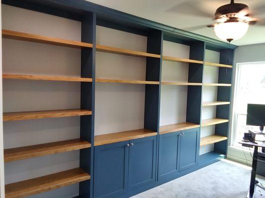 Custom bookcase with cabinets- dark blue with stained shelving