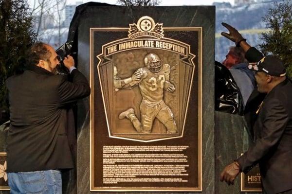 Franco Harris and Frenchy Fuqua unveil the Immaculate Reception Monument.