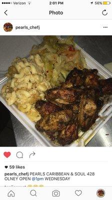 Jerk wings over rice and peas, macaroni & cheese and cabbage