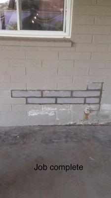 Block wall repaired after plumbing work completed