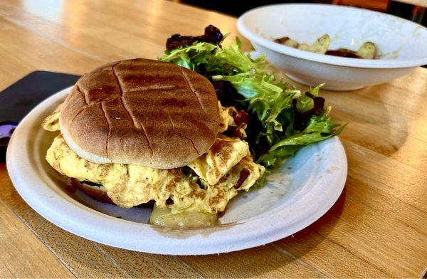 Bacon, egg and cheddar cheese on a fresh-baked roll, served with side salad (and more of those roasted potatoes)...