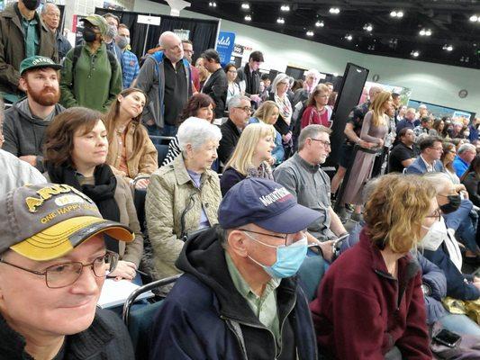 Travel show people watching a lecture by Rick Steves.