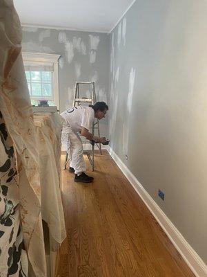 Jose, Son of Garcia & son prepping the wall for painting