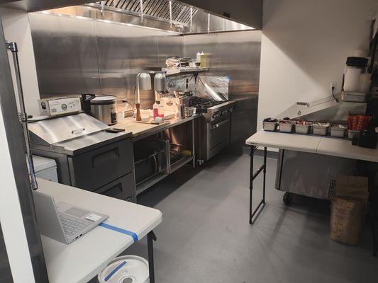 Inside our small super clean and organized kitchen suite ready to cook and serve you!