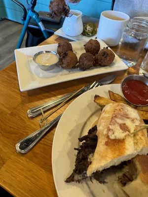 Corn fritters , short rib steak and cheese sandwich with house cut fries